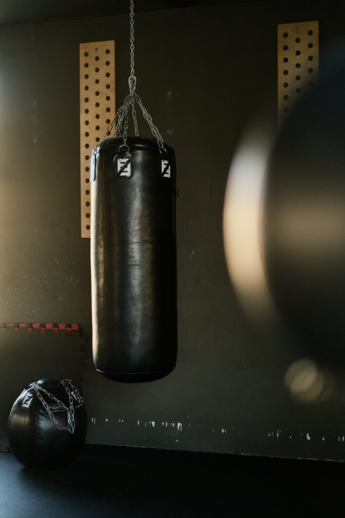 A photo of a punch bag in an empty gym