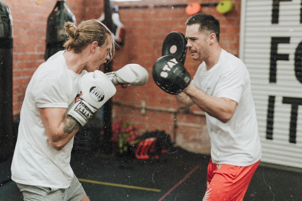 Boxer doing padwork with a coach