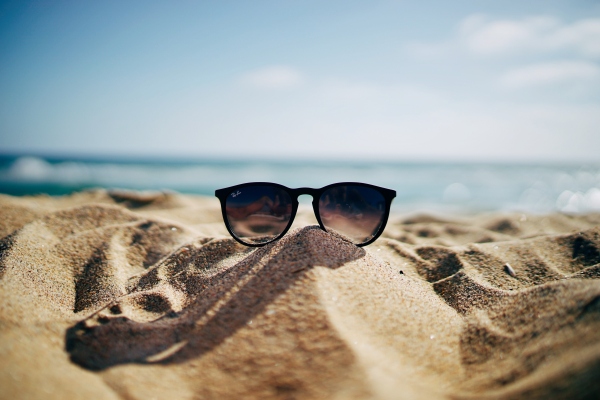 Sunglasses resting on a beach