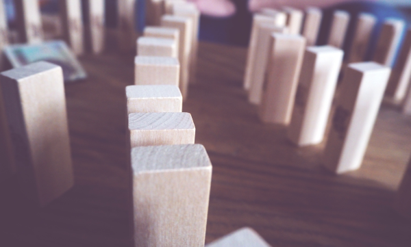 Wooden blocks lined up like dominoes